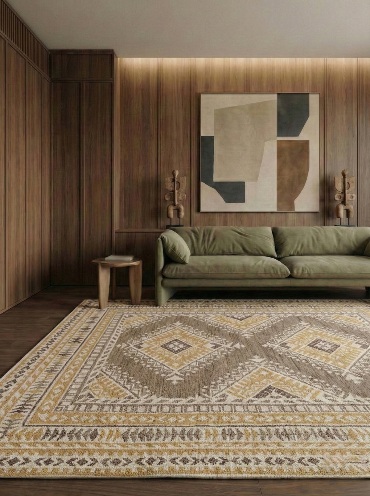Living room with a green sofa, patterned rug, and abstract wall art.