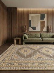 Living room with a green sofa, patterned rug, and abstract wall art.